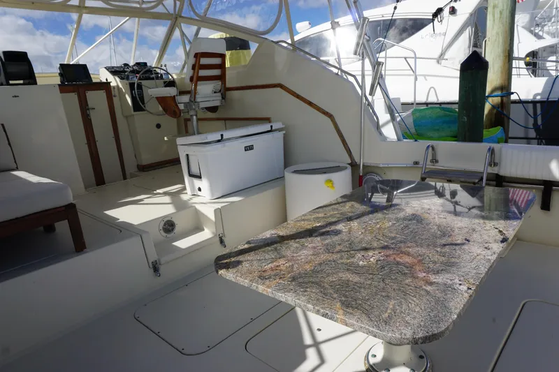 Slide: The Image of Interior of 1985 Hatteras 36 Convertible yacht with granite table and seating. - 34