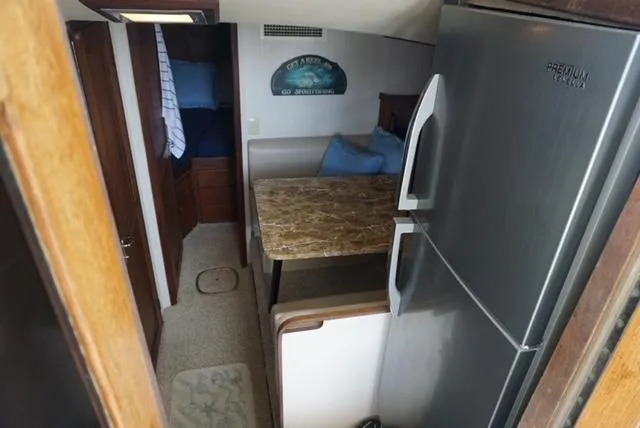 Slide: The Image of Interior of 1985 Hatteras 36 Convertible with dining area and refrigerator. - 35