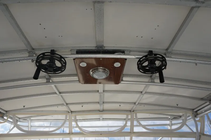 Slide: The Image of Ceiling of 1985 Hatteras 36 Convertible boat with mounted fishing rod holders. - 38