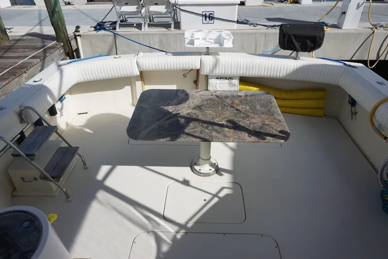 Slide: The Image of Cockpit of 1985 Hatteras 36 Convertible with table and seating. - 40