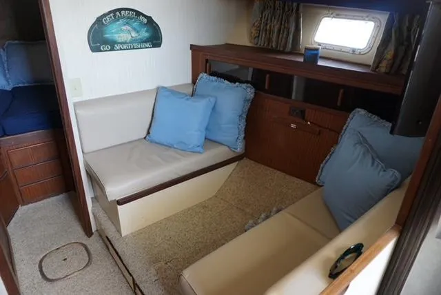 Slide: The Image of Interior of 1985 Hatteras 36 Convertible with seating area and blue cushions. - 45