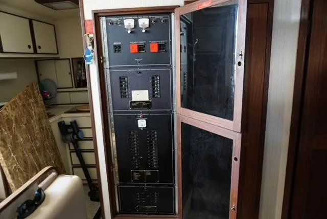 Slide: The Image of Electrical panel inside a 1985 Hatteras 36 Convertible boat. - 48