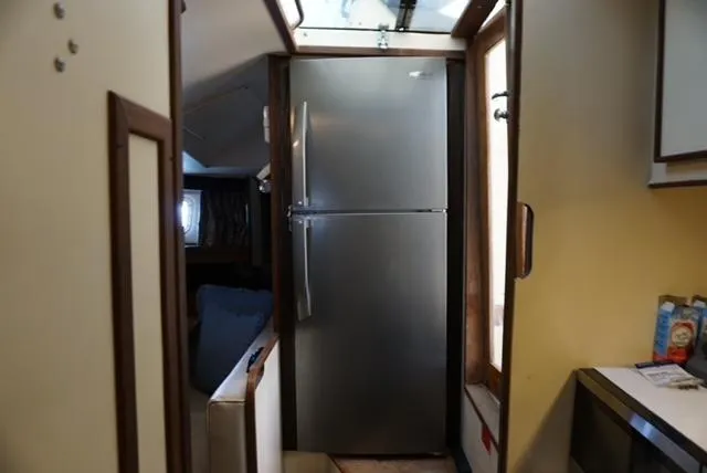 Slide: The Image of Interior of 1985 Hatteras 36 Convertible yacht with stainless steel refrigerator. - 49