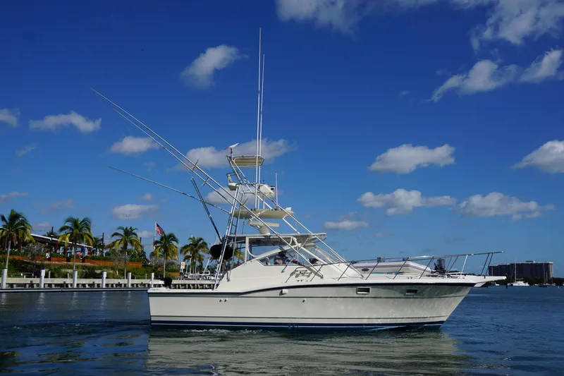 Slide: The Image of 1985 Hatteras 36 Convertible yacht on calm water with blue sky. - 9