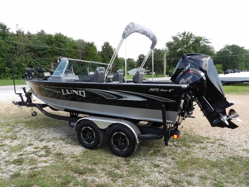 Slide: The Image of 2019 Lund 1975 Pro V Sport fishing boat on trailer, parked outdoors. - 10