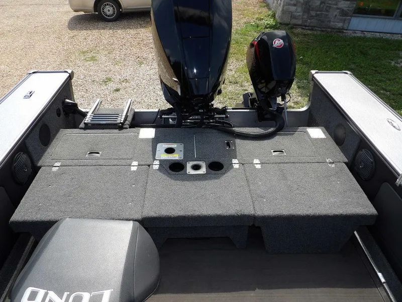 Slide: The Image of 2019 Lund 1975 Pro V Sport boat interior with motor and storage compartments. - 12