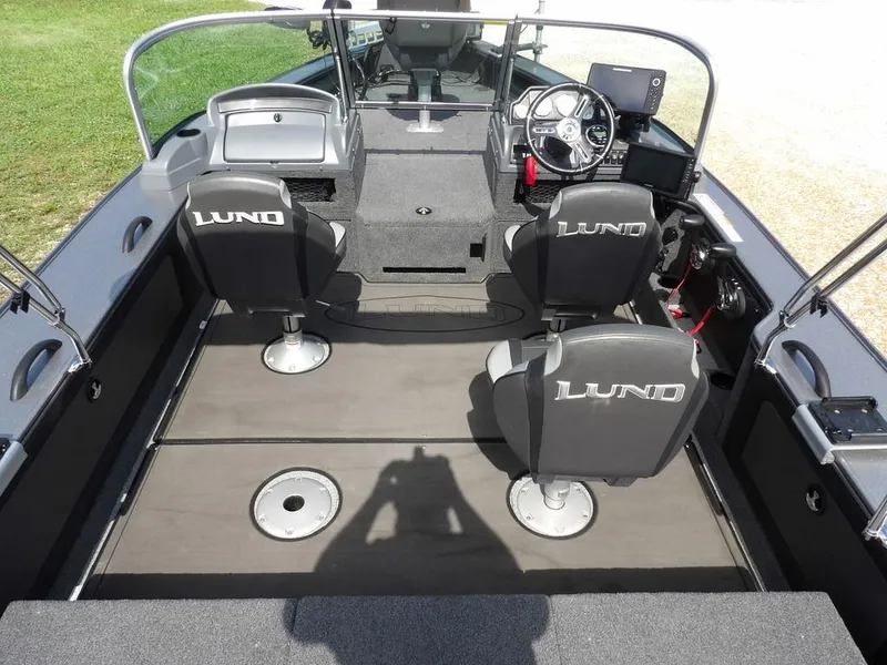 Slide: The Image of Interior of 2019 Lund 1975 Pro V Sport boat with seating and steering console. - 13