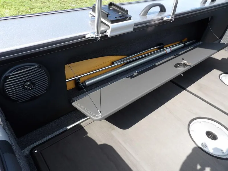 Slide: The Image of Interior of 2019 Lund 1975 Pro V Sport boat showing storage compartment and speaker. - 14