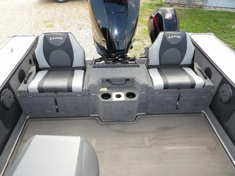Slide: The Image of 2019 Lund 1975 Pro V Sport boat interior with seating and motor. - 19