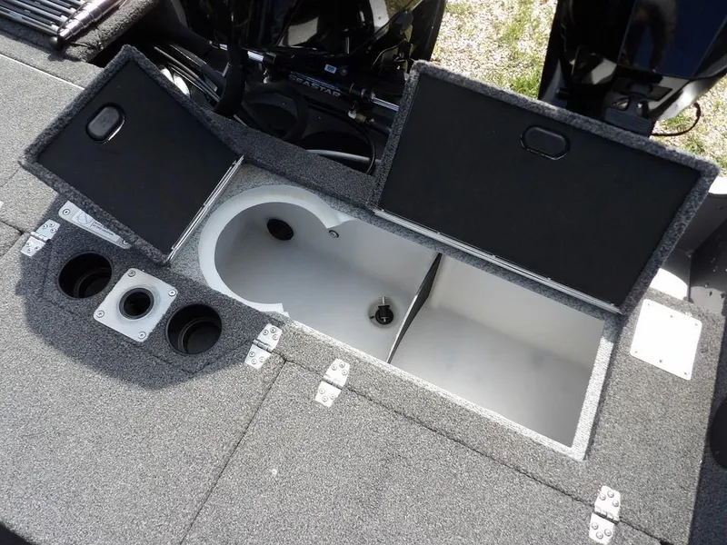 Slide: The Image of 2019 Lund 1975 Pro V Sport boat storage compartments with open lids and cup holders. - 20