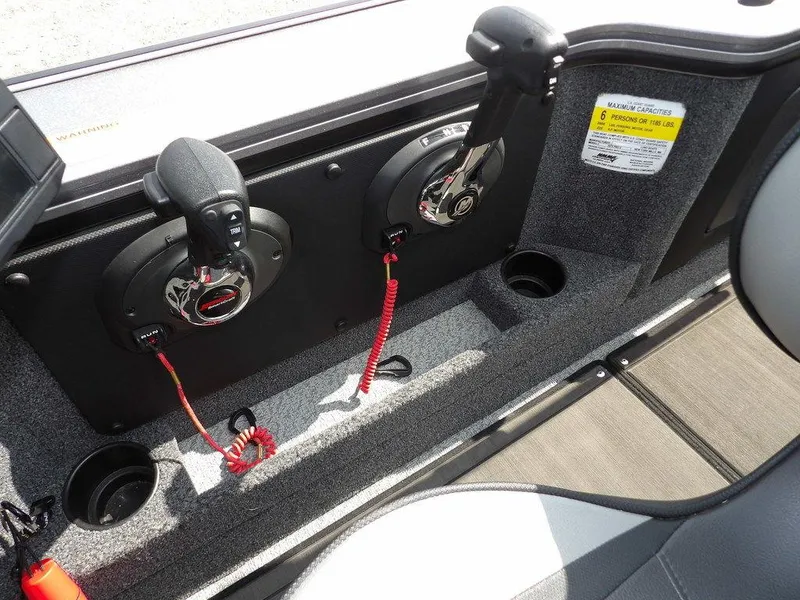 Slide: The Image of Interior controls of a 2019 Lund 1975 Pro V Sport boat, featuring dual throttle levers. - 21