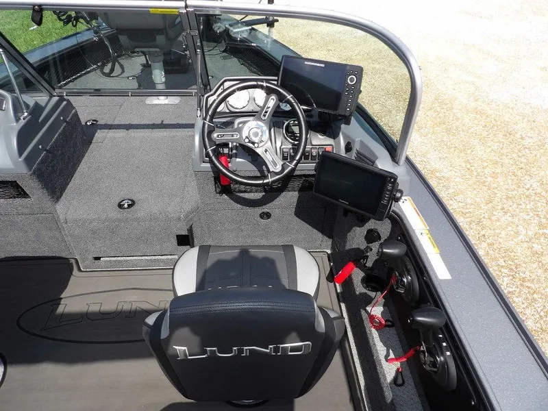 Slide: The Image of Interior of 2019 Lund 1975 Pro V Sport boat with steering wheel and navigation screens. - 25