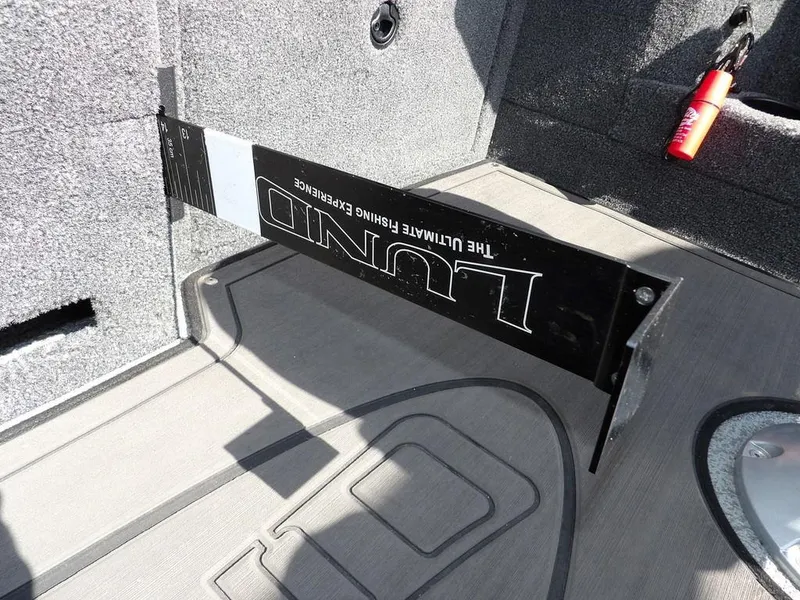 Slide: The Image of Interior of 2019 Lund 1975 Pro V Sport boat with measuring board and storage. - 32