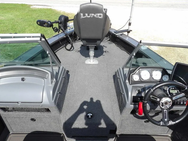 Slide: The Image of 2019 Lund 1975 Pro V Sport boat interior with steering wheel and dashboard controls. - 41