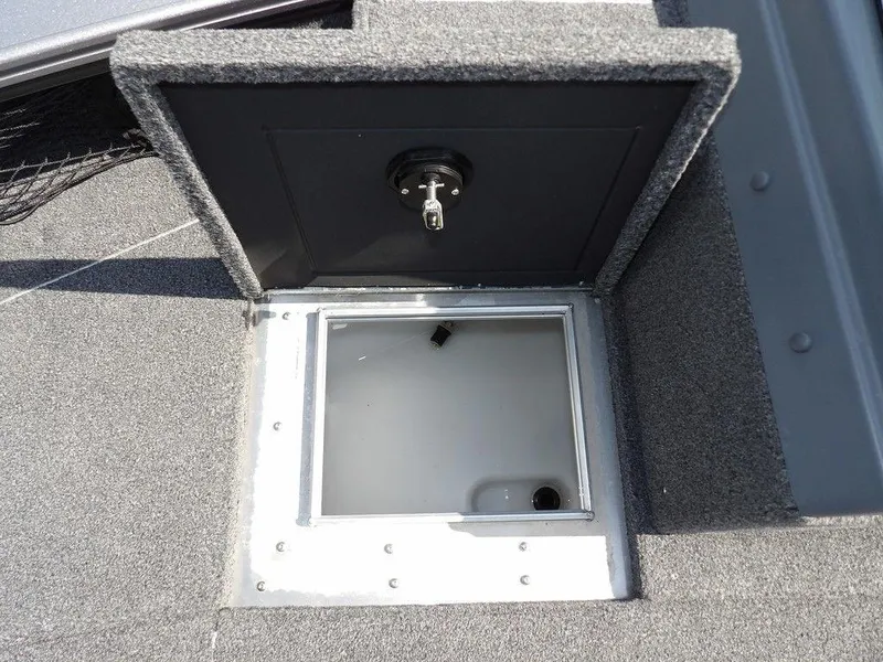 Slide: The Image of Open storage compartment on 2019 Lund 1975 Pro V Sport boat, featuring secure lock mechanism. - 43