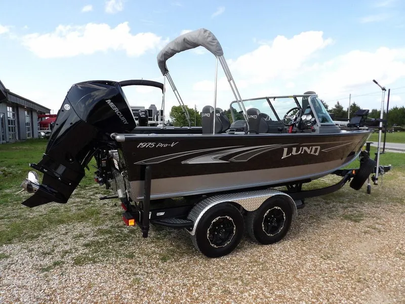 Slide: The Image of 2019 Lund 1975 Pro V Sport boat on trailer, featuring Mercury outboard motor. - 5