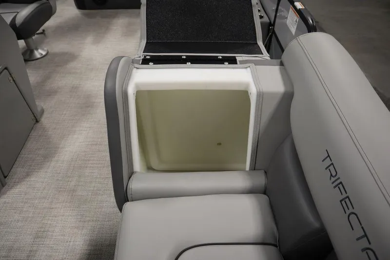 Slide: The Image of 2023 Trifecta 24UL CS 2.75 boat with open storage compartment in gray seating. - 21