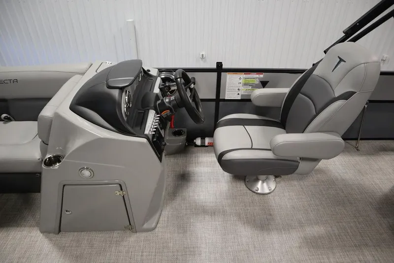 Slide: The Image of 2023 Trifecta 24UL CS 2.75 boat interior with captain's chair and control console. - 24