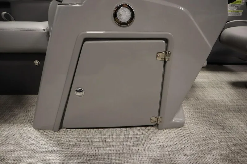 Slide: The Image of 2023 Trifecta 24UL CS 2.75 boat storage compartment with gray door and chrome hardware. - 25
