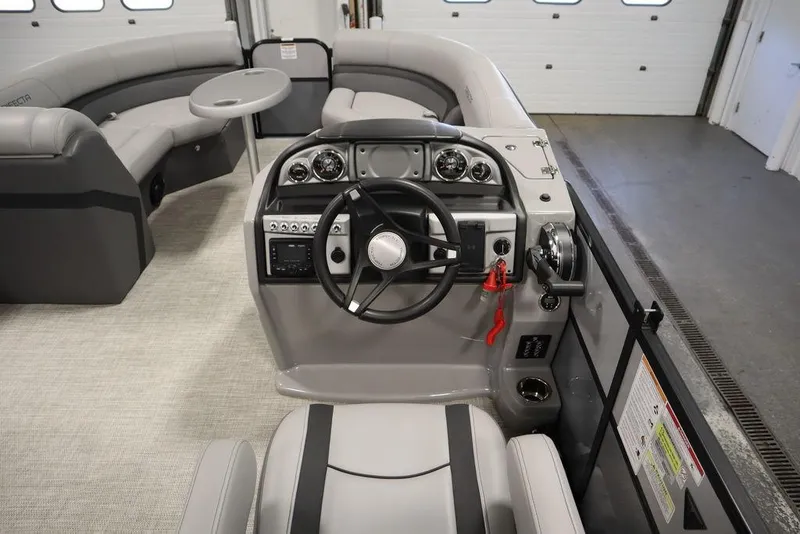 Slide: The Image of 2023 Trifecta 24UL CS 2.75 boat interior with steering console and seating area. - 27