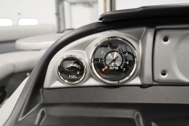 Slide: The Image of Close-up of 2023 Trifecta 24UL CS 2.75 boat dashboard with fuel and RPM gauges. - 29