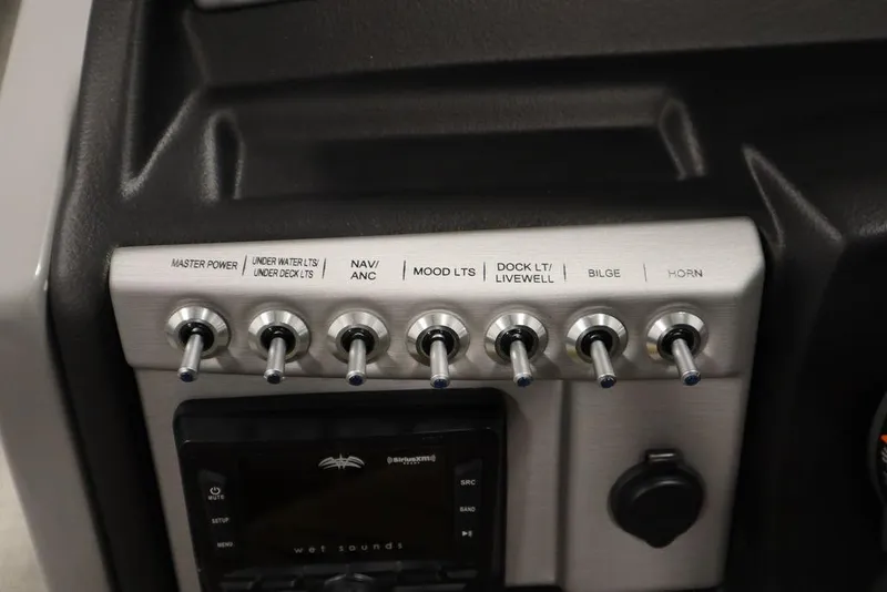 Slide: The Image of Control panel of 2023 Trifecta 24UL CS 2.75 boat with labeled switches. - 31