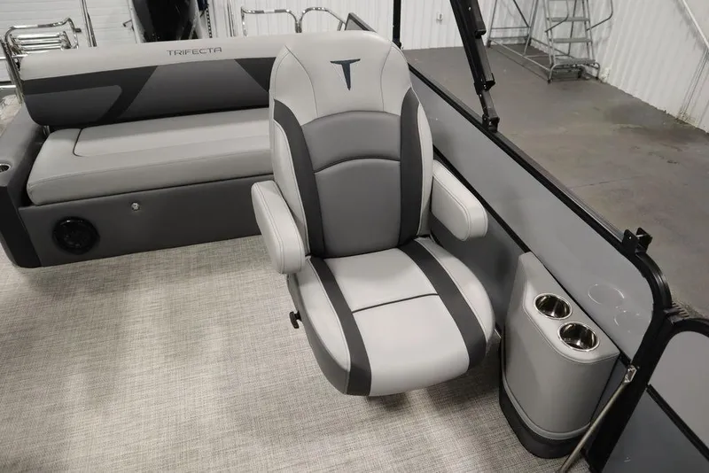 Slide: The Image of 2023 Trifecta 24UL CS 2.75 boat interior with gray captain's chair and cup holders. - 40
