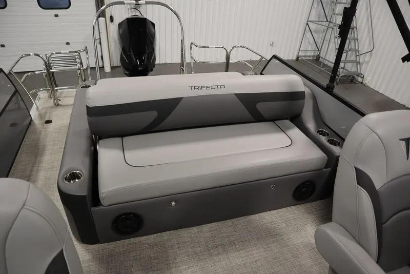 Slide: The Image of 2023 Trifecta 24UL CS 2.75 pontoon boat interior with gray seating and cup holders. - 42