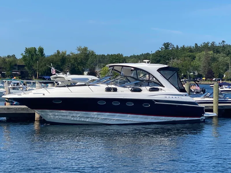 Slide: The Image of 2005 Regal Commodore 4260 yacht docked at a marina. - 0