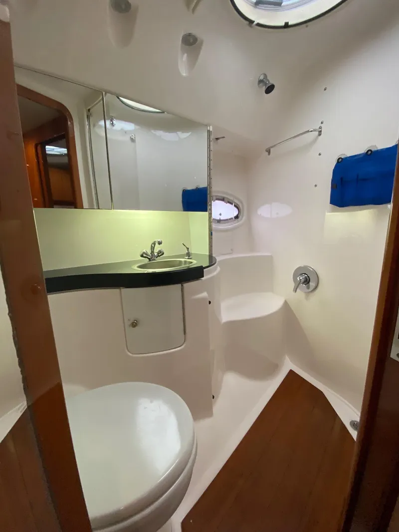Slide: The Image of 2005 Regal Commodore 4260 yacht bathroom with modern fixtures and wooden flooring. - 11