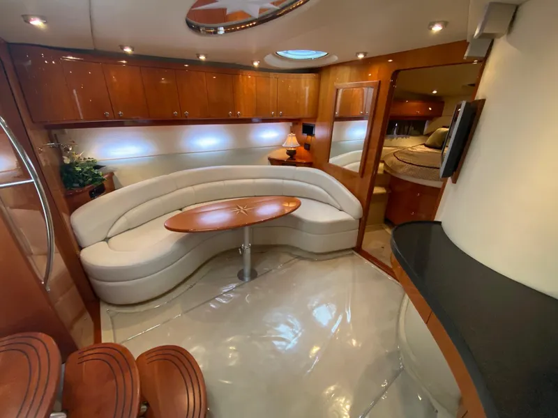 Slide: The Image of Luxurious interior of 2005 Regal Commodore 4260 yacht with curved seating and wooden cabinetry. - 13