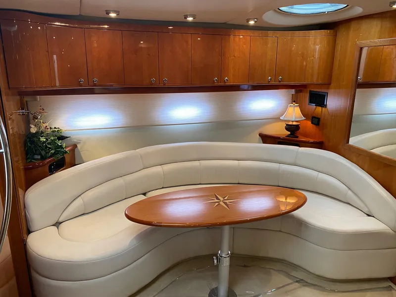 Slide: The Image of Luxurious interior of 2005 Regal Commodore 4260 yacht with curved seating and wooden table. - 14