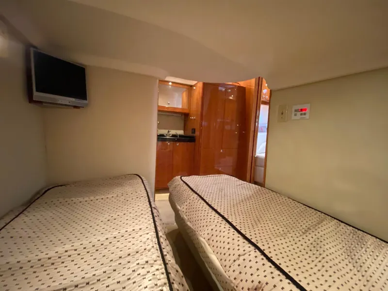 Slide: The Image of 2005 Regal Commodore 4260 cabin with twin beds and TV. - 16