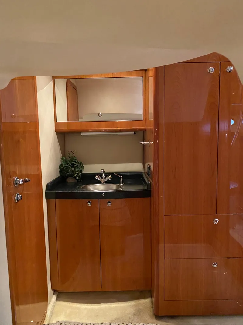 Slide: The Image of 2005 Regal Commodore 4260 yacht interior with wooden cabinetry and sink. - 18