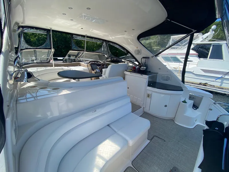 Slide: The Image of 2005 Regal Commodore 4260 yacht interior with white seating and helm station. - 3