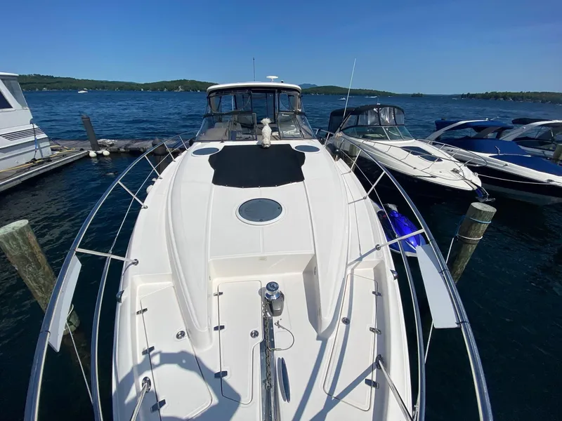 Slide: The Image of 2005 Regal Commodore 4260 yacht docked at a marina on a sunny day. - 5