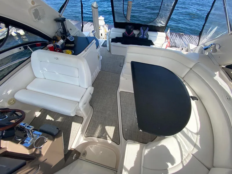 Slide: The Image of 2005 Regal Commodore 4260 boat interior with white seating and black table. - 6