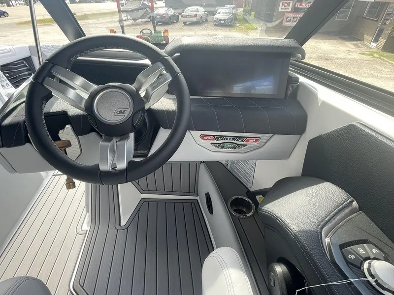 Slide: The Image of 2022 Nautique Super Air Nautique G23 boat cockpit with steering wheel and control panel. - 10