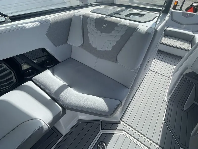 Slide: The Image of Interior seating of 2022 Nautique Super Air Nautique G23 boat with grey upholstery. - 11