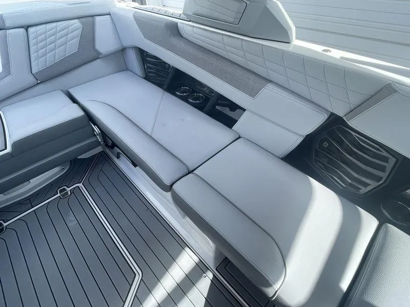 Slide: The Image of Interior seating of 2022 Nautique Super Air Nautique G23 boat with gray upholstery. - 12