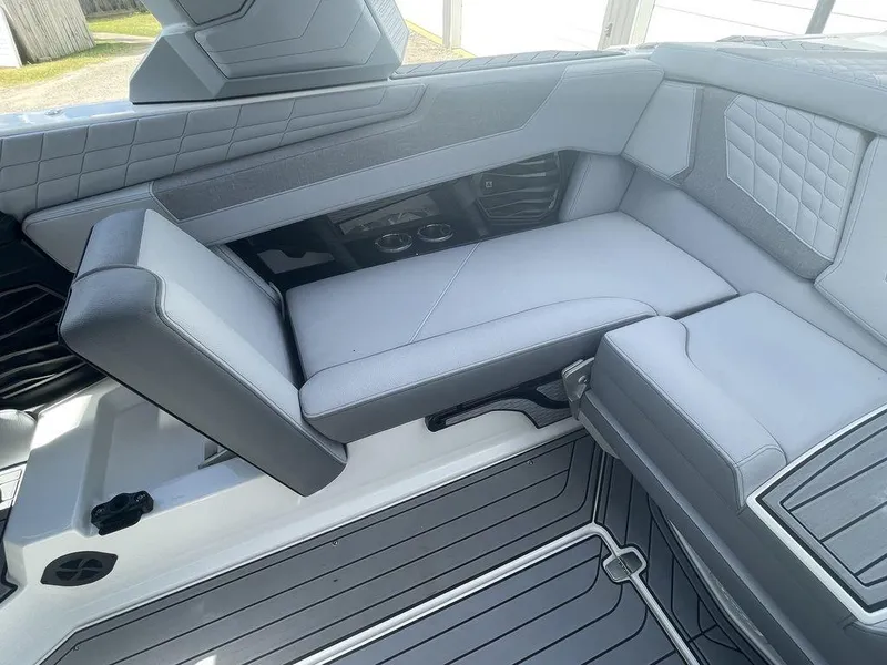 Slide: The Image of 2022 Nautique Super Air Nautique G23 interior seating with gray upholstery. - 13