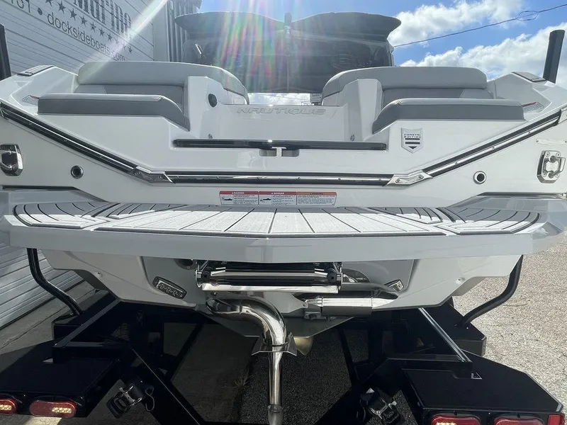 Slide: The Image of 2022 Nautique Super Air Nautique G23 boat rear view with swim platform. - 4
