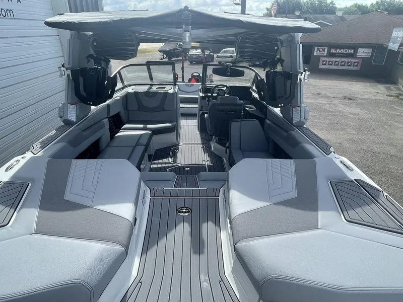 Slide: The Image of 2022 Nautique Super Air Nautique G23 boat interior with gray seating and sunshade. - 5