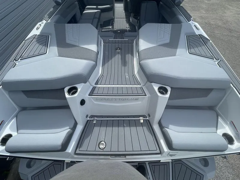 Slide: The Image of 2022 Nautique Super Air Nautique G23 boat interior with gray seating and deck. - 6