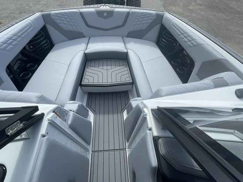 Slide: The Image of 2022 Nautique Super Air Nautique G23 boat interior with gray seating and flooring. - 7