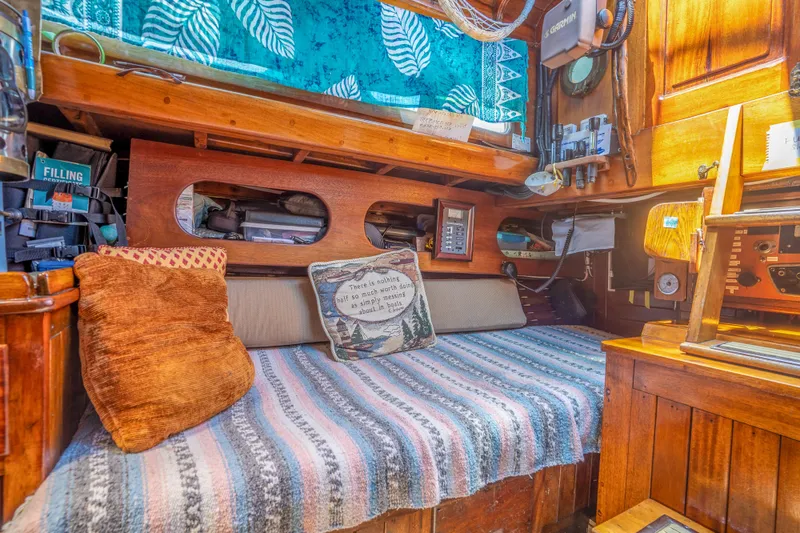 Slide: The Image of Cozy interior of a 1950 Custom Cornu Sloop with wooden furnishings and colorful cushions. - 12