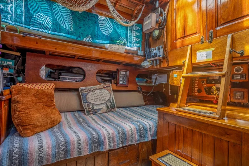 Slide: The Image of Cozy interior of a 1950 Custom Cornu Sloop with wooden furnishings and nautical decor. - 21