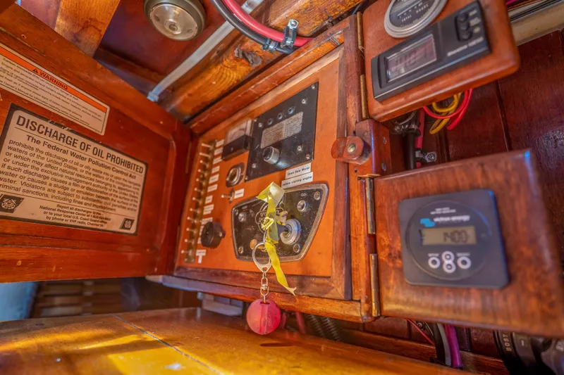 Slide: The Image of 1950 Custom Cornu Sloop control panel with oil discharge warning sign. - 22