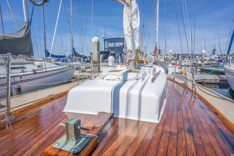 Slide: The Image of 1950 Custom Cornu Sloop sailboat with polished wooden deck docked at marina. - 25