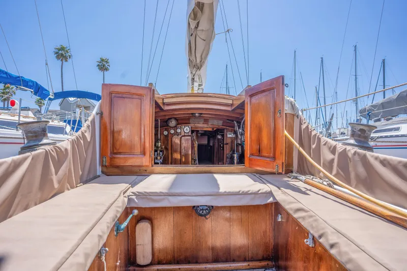 Slide: The Image of 1950 Custom Cornu Sloop sailboat interior with open wooden cabin doors. - 5